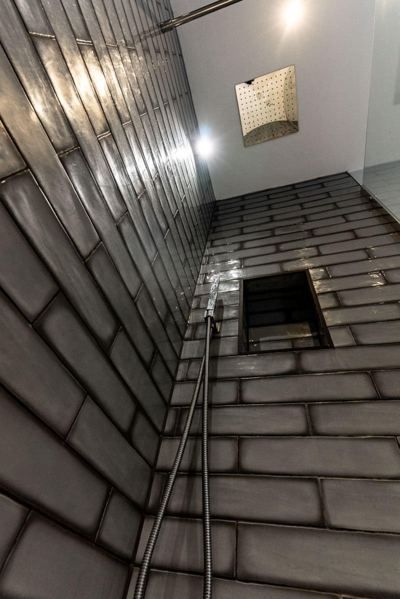 Shower with grey brick tiles
